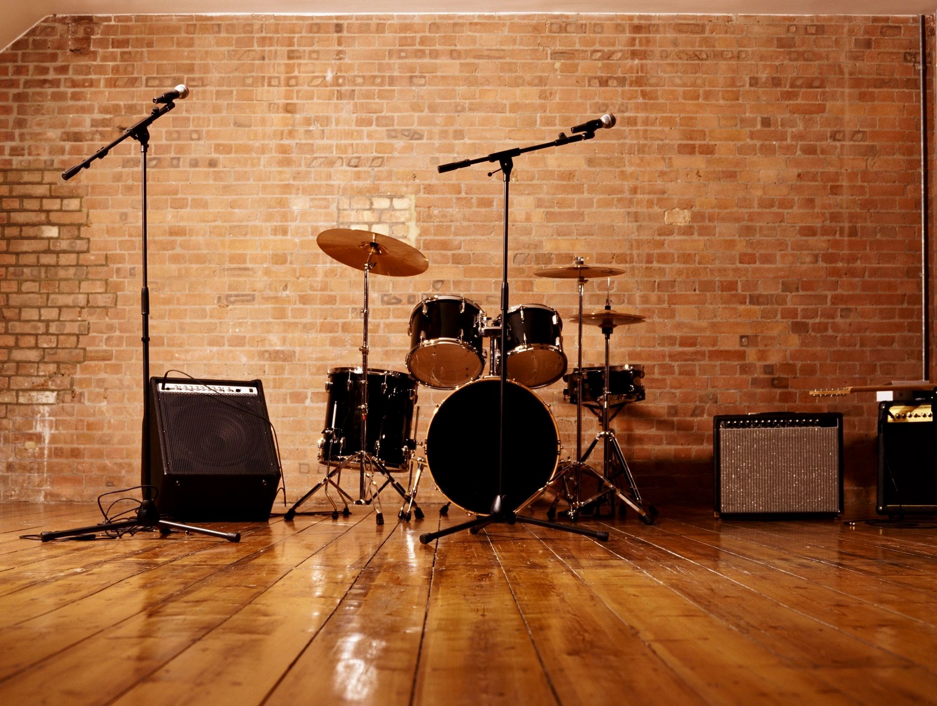 Professional music studio with drum kit and brick walls